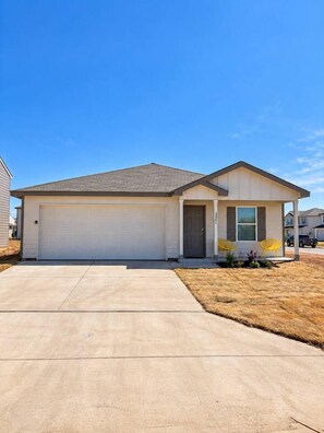 A single-story house with a garage, a covered porch, and a small front yard. - Spacious 4BR Retreat | Near Dyess & Data Centers (Abilene)