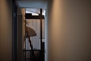 A corridor with a wooden railing and a person standing near it. - Maru  (Shimotakai-gun)