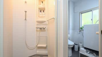 A modern bathroom with a shower, toilet, and sink.