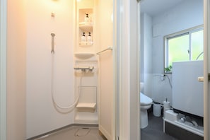 A modern bathroom with a shower, toilet, and sink. - Zeroichi Hotel Art Ohori  (Fukuoka)