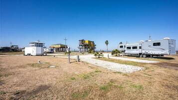 A campsite with RVs, a small building, and a clear sky.