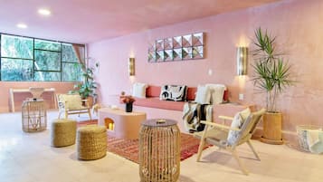 A modern living room with a sofa, chairs, a coffee table, and decorative items.