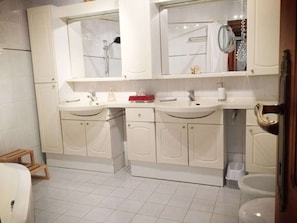 A bathroom with two sinks, a shower, and a toilet. - Cottage in Szigliget With Swimming Pool (Szigliget)