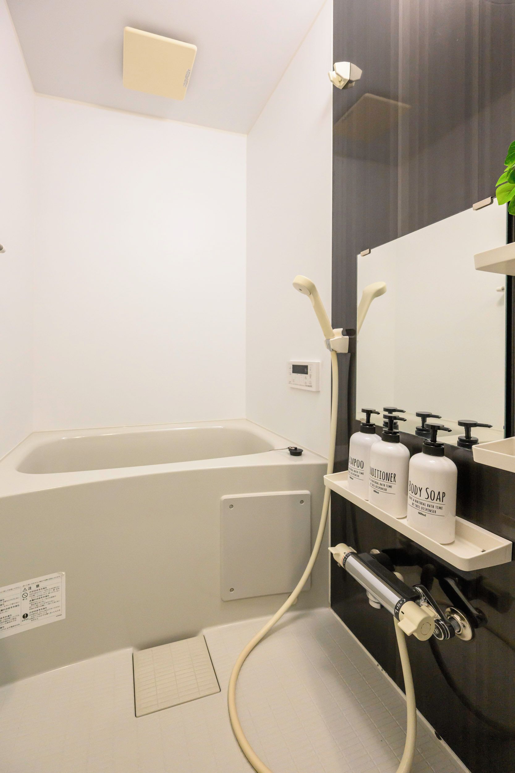 A modern bathroom with a bathtub, a shower, and a vanity with toiletries.