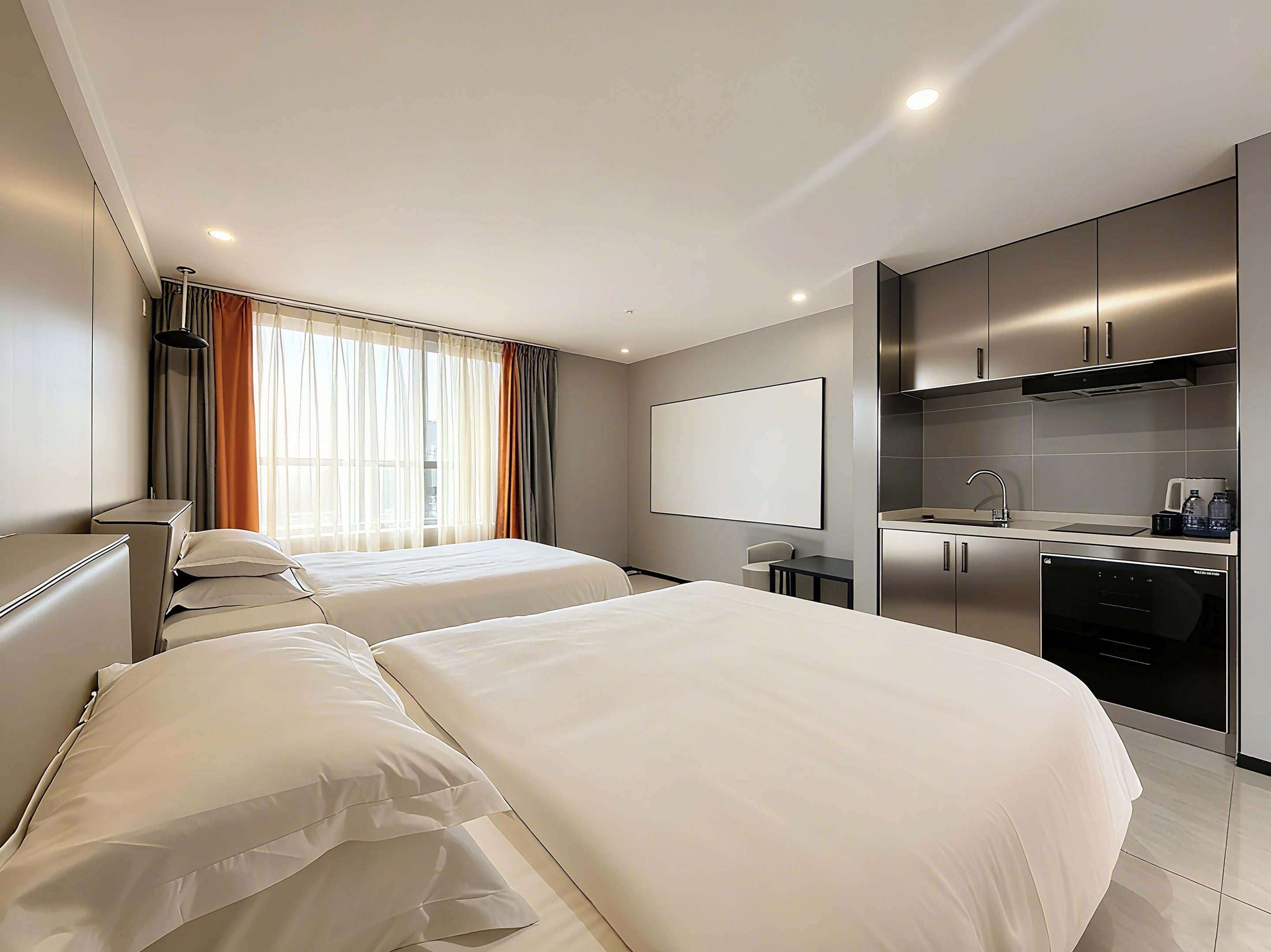 A hotel room with two beds, a kitchenette, and a large window with curtains.