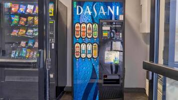 A vending machine with a blue and white design, offering snacks and drinks.