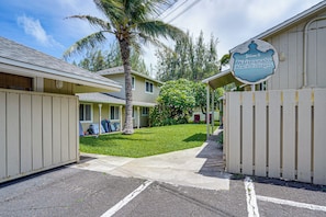 A gated entrance to a residential area with a sign welcoming to Waimanalo Beach Cottages. - Walk to Shore! Waimanalo Beach Cottages, Unit 9 (Waimanalo)
