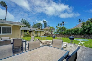 A patio area with outdoor furniture, a barbecue grill, and a swimming pool. - Walk to Ocean! Waimanalo Beach Cottages: Unit 5 (Waimanalo)