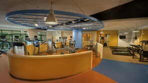 A gym with cardio equipment, weight machines, and a reception desk. - Ocean View Escape: 2BR Villa at Marriott’s Oceana Palms (Riviera Beach)