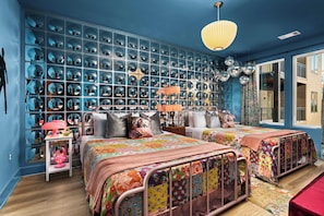 Ein Zimmer mit zwei Betten, einer Spiegelwand und einer hängenden Discokugel.