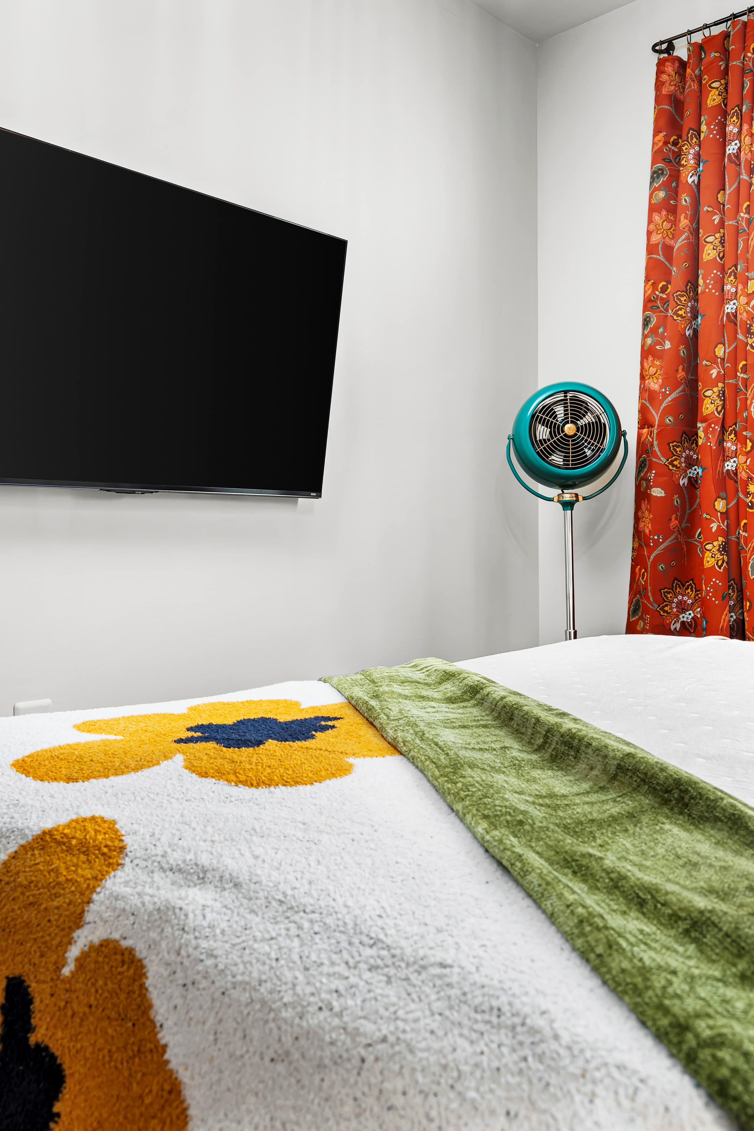 When it's time to wind down, settle in with your own TV and a bedroom full of retro color.