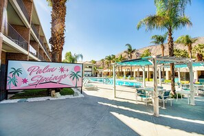 A hotel sign with palm trees and a pool area. - 2X2BR OasisNearCoachellaw/resort Style-Amenities (Palm Springs)