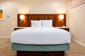 A hotel room with a large bed, two bedside tables, a headboard with integrated lighting, and a wall-mounted thermostat. - 2X2BR OasisNearCoachellaw/resort Style-Amenities (Palm Springs)
