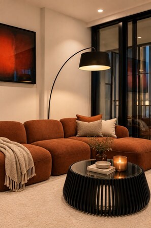 A modern living room with a sofa, a round coffee table, a floor lamp, and a painting on the wall. - Luxurious Melbourne City Escape with State of the Art Pool, Gym & Sauna (Southbank)