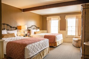 A hotel room with two beds, a nightstand, a lamp, and a window with curtains. - Lajitas Golf Resort (Terlingua)