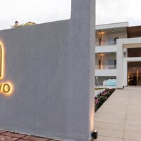 Un edificio moderno con una entrada destacada y un camino bien iluminado que lleva a la entrada.