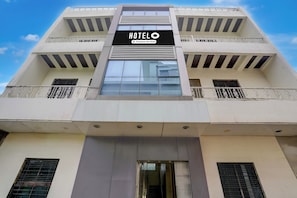 A hotel building with a sign reading 'HOTELO Company Serviced'. - Hotel O Sai Teerth Theme Park (Shirdi)