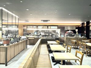 A modern restaurant interior with a long counter, seating area, and kitchen in the background. - Daiwa Roynet Hotel Naha-omoromachi Premier (Naha)