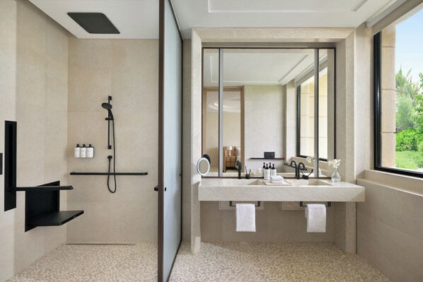 A modern bathroom with a shower, a large mirror, a vanity with a sink, and a window providing a view of the outdoors. - Intercontinental The Red Sea Resort by IHG (Umluj)