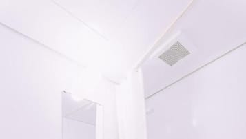 A bathroom with a toilet, sink, and bathtub.