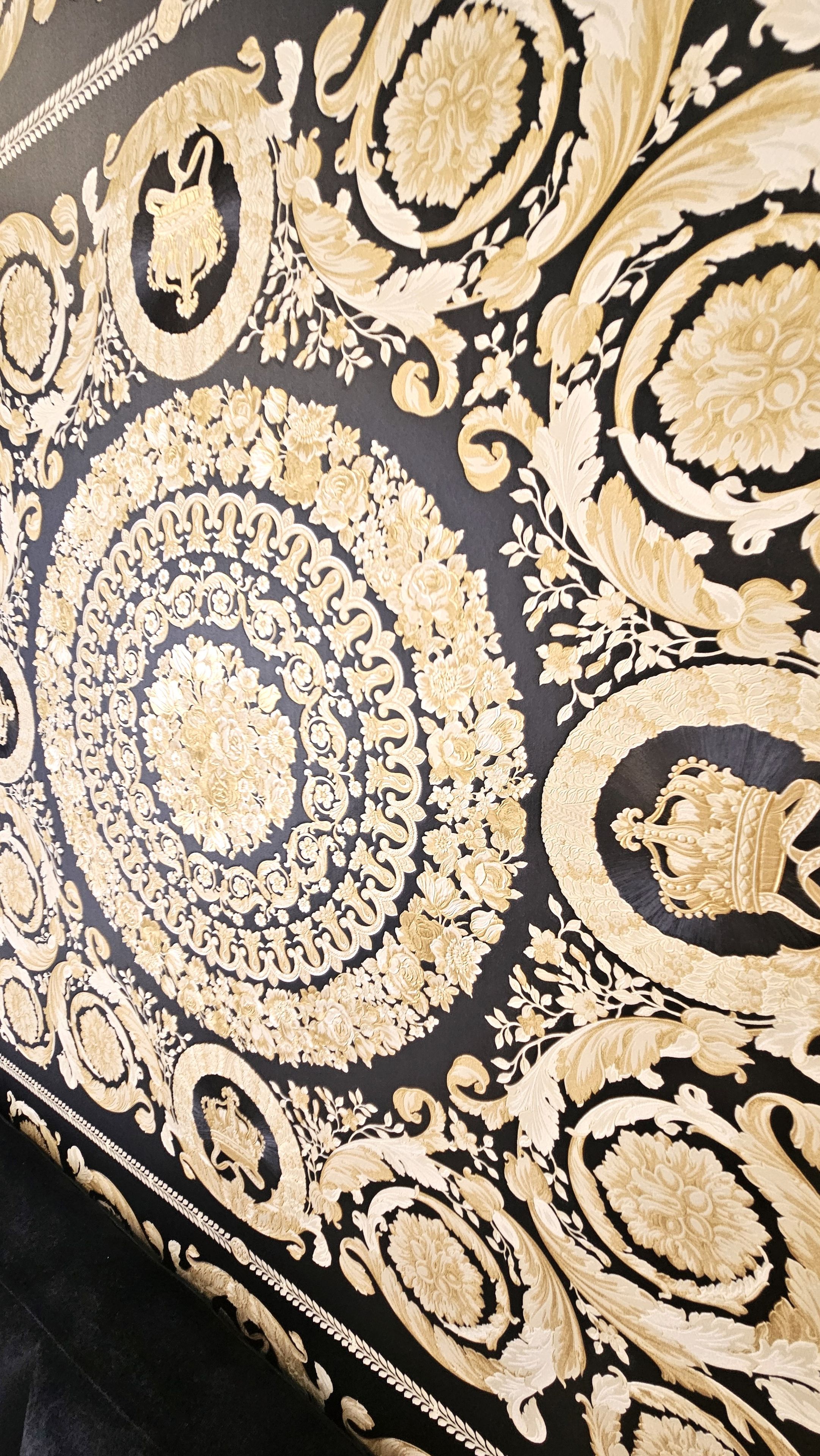 A close-up of a black and gold patterned fabric.