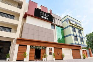 A multi-story building with a prominent sign for 'Collecton Oyo-Serviced.' - Classic Hotel Dream Palace (Danapur)
