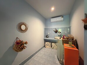 A compact kitchen with a refrigerator, a sink, and a countertop.