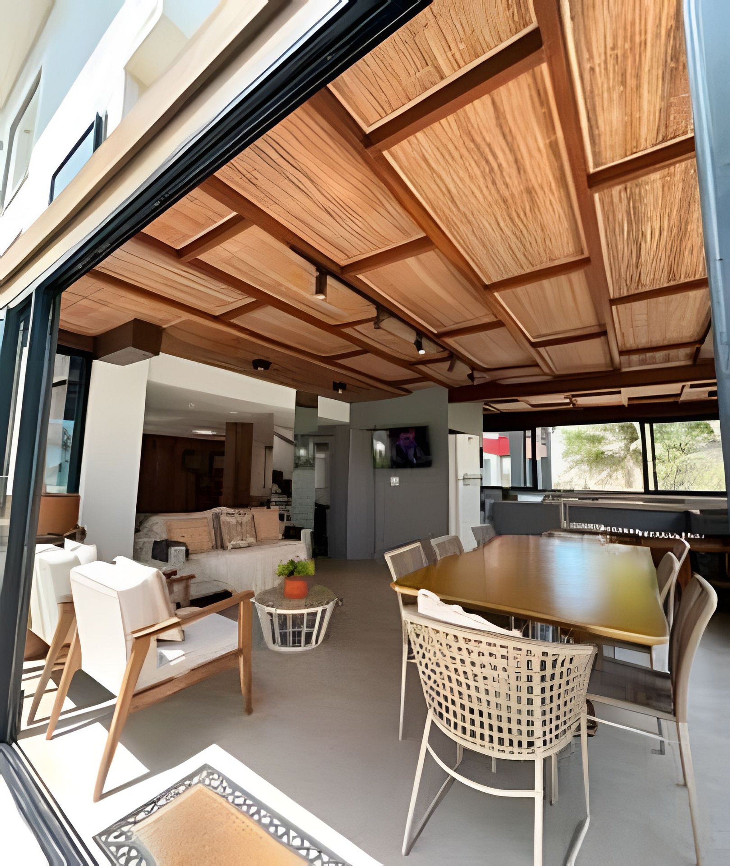 An open-plan living area with a dining table, chairs, and a sofa.