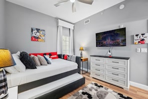 A bedroom with a bed, a TV, and Mickey Mouse themed decor. - 4505 Minutes to Magic! 3/3 Resort Condo Near Disney (Orlando)