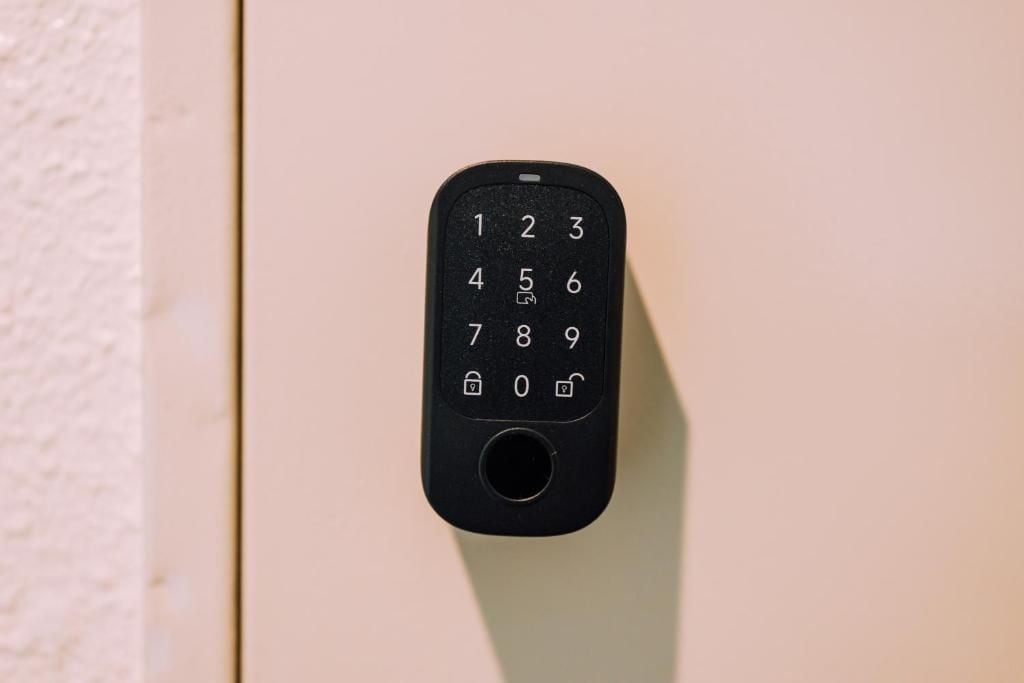 A black numeric keypad mounted on a beige wall.