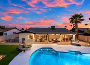 A residential property with a swimming pool, outdoor seating area, and a view of the sunset. - The Belmont - Kierland (Scottsdale)