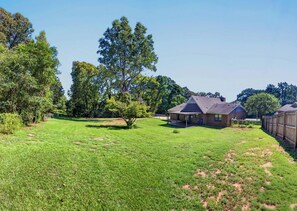 A residential property with a house, a covered patio, and a fenced yard. - Near 17 Springs Spacious 3BR Millbrook Home (Millbrook)