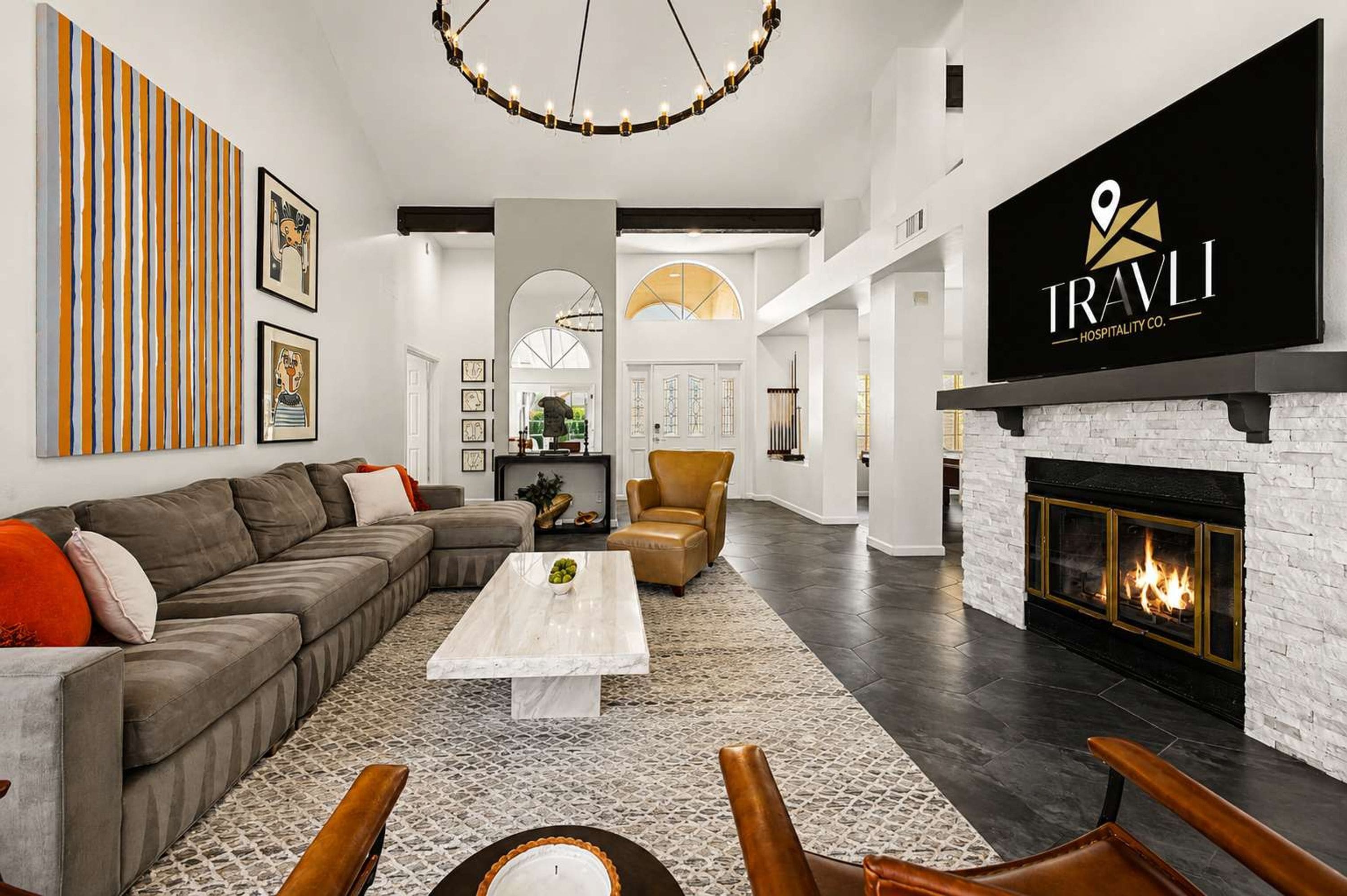 A spacious living room with a sectional sofa, a coffee table, and a fireplace.