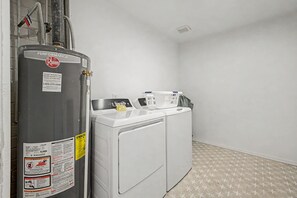 A laundry room with a water heater, washing machine, and dryer. - NEW Ocotillo Luxe Retreat Scottsdale Old Town (Scottsdale)