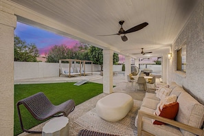 A covered outdoor patio with a seating area, a dining table, and a barbecue grill. - NEW The Fairmont Kierland Pool Spa Daybeds (Scottsdale)