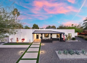 A modern house with a patio, a flag, and a well-maintained garden. - The Brexton Luxe Scottsdale Resort-style Oasis (Scottsdale)