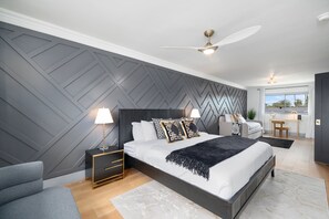 A modern bedroom with a bed, bedside tables, and a ceiling fan. - NEW Luna Lunera Gameroom Pool Sleeps 14 (Scottsdale)