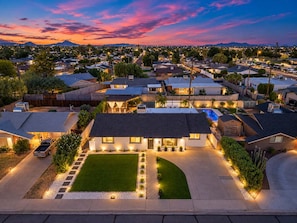 A residential area with houses, a swimming pool, and a well-lit driveway. - NEW The Tipsy Cactus Old Town Oasis Pool Bar Putt (Scottsdale)