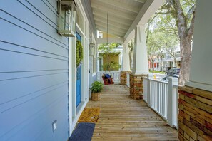 A covered porch with a wooden floor, a blue door, and a white railing. - 5 Mi to UF! Luxury 2-unit Combo w/ Hot Tub (Gainesville)