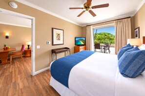 A hotel room with a bed, a desk, a chair, a television, and a balcony with a view of greenery. - Honua Kai | Mountain View 1 BR | Free Car w/ 6+ Nights | HKK-230 (Lahaina)