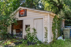 A small, single-story building with a basketball court sign, a door, and a window. - Perfect for Groups! 4-Bedroom Home Near the Waterfront + Dining (Washington)