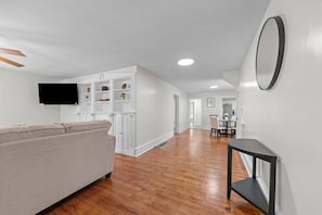 A modern interior with a sofa, a dining area, and a kitchen. - Perfect for Groups! 4-Bedroom Home Near the Waterfront + Dining (Washington)