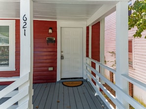A red house with a white door, a mailbox, and a welcome mat. - Perfect for Groups! 4-Bedroom Home Near the Waterfront + Dining (Washington)