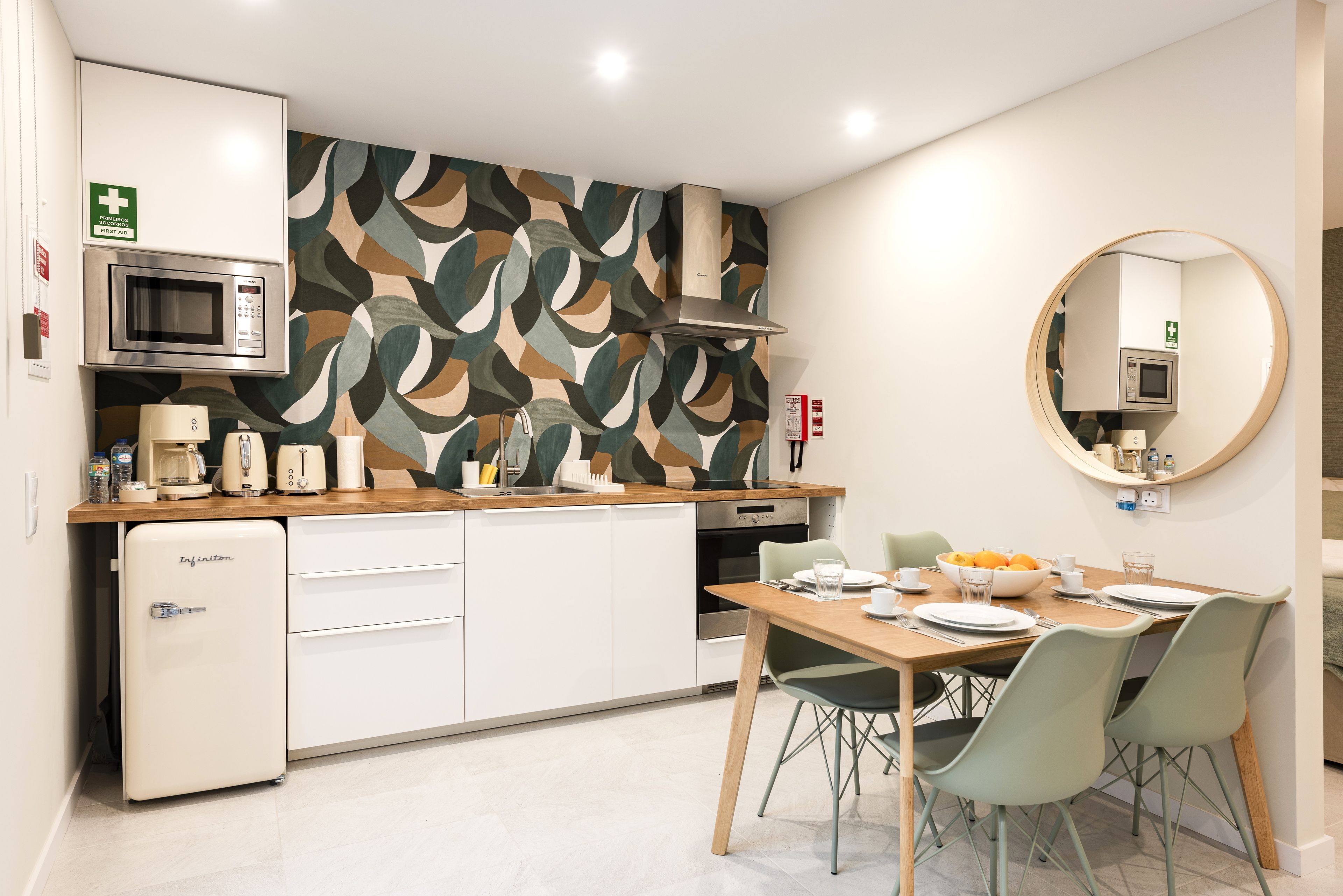 Stylish kitchenette with retro fridge, bold tile & dining for four