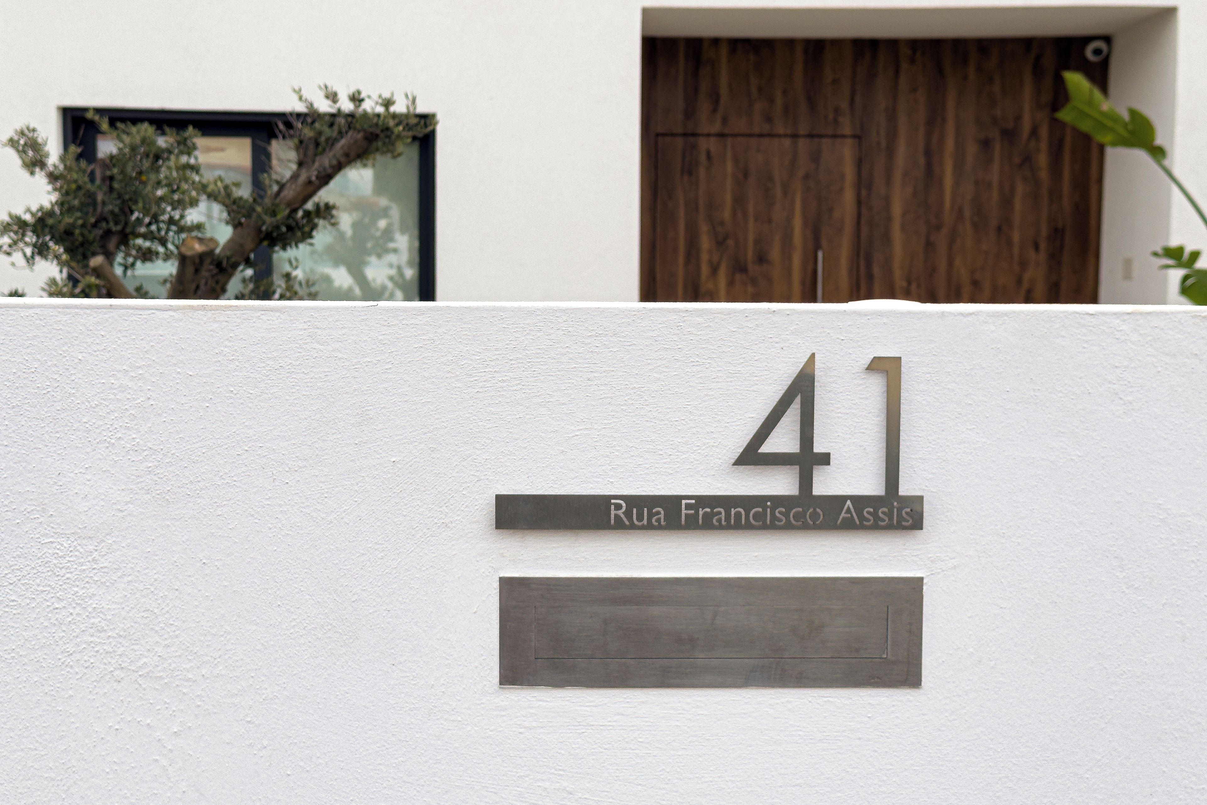 Contemporary curb appeal—bold 41 signage and warm wood front door
