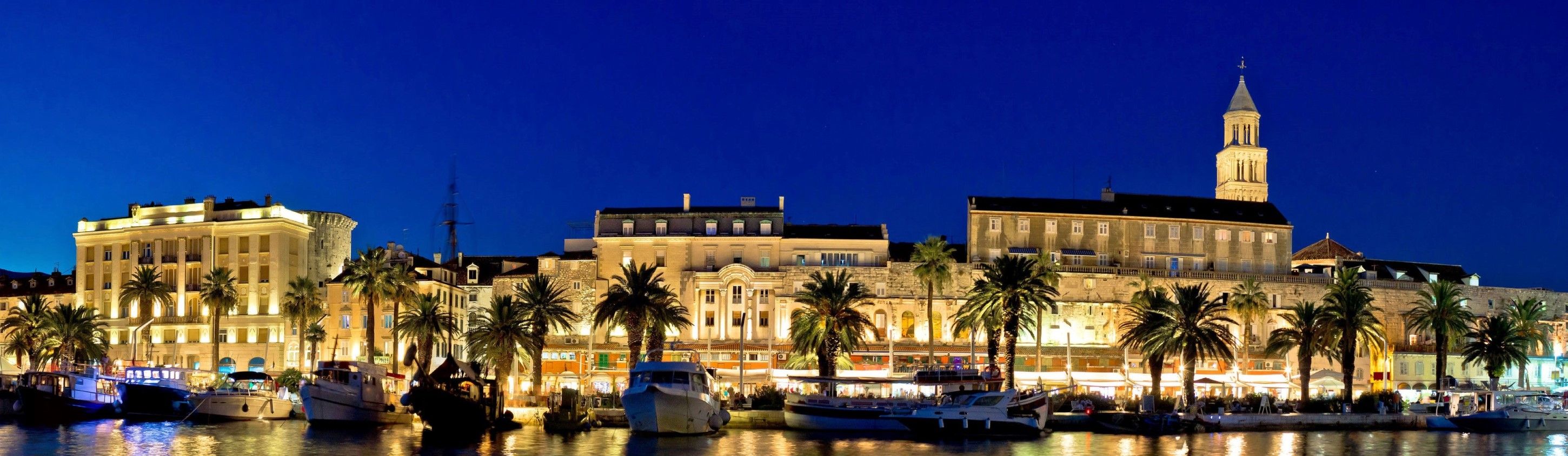 A waterfront view of Split with historic buildings and boats.