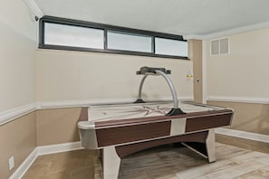 A pool table with a star design, located in a room with beige walls and a window above it. - Maisons-Sur-Mer 1602 Ocean View 2BR- Outdoor Pool (Myrtle Beach)