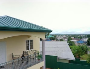 A building with a balcony, a door, and a window. - A welcoming light open concept two bedroom apartment. (San Juan)