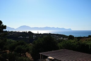 A coastal landscape with a view of the sea and mountains in the distance. - Casa Marina—Room with a Sea View (Sicilia)