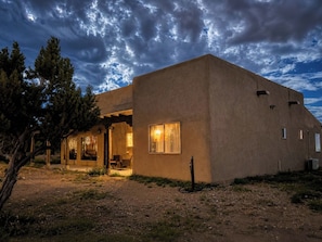 A single-story building with a flat roof, a covered porch, and a small window.